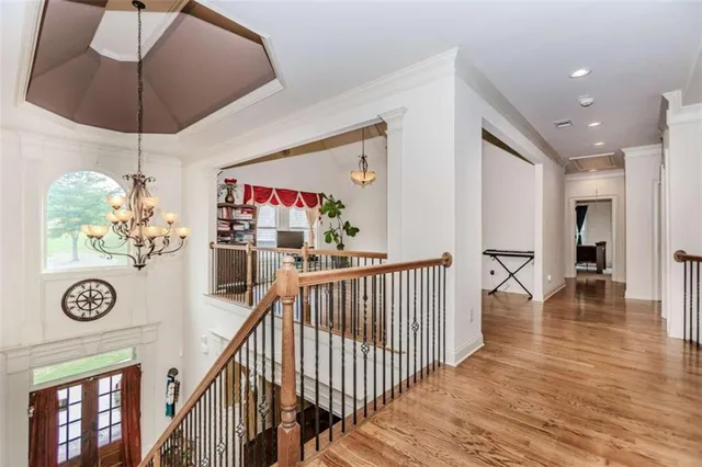a view of entryway and hall with wooden floor