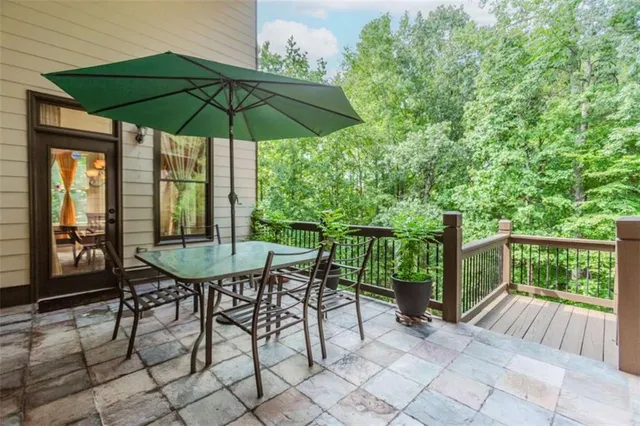 a view of balcony with chairs and umbrella