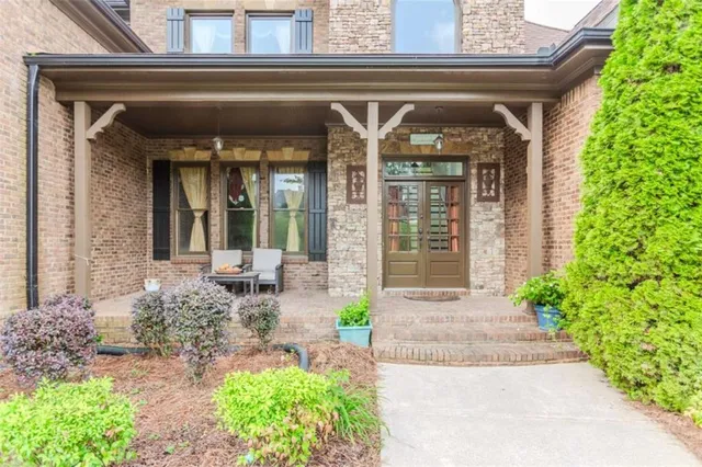 a front view of a house with outdoor seating and plants