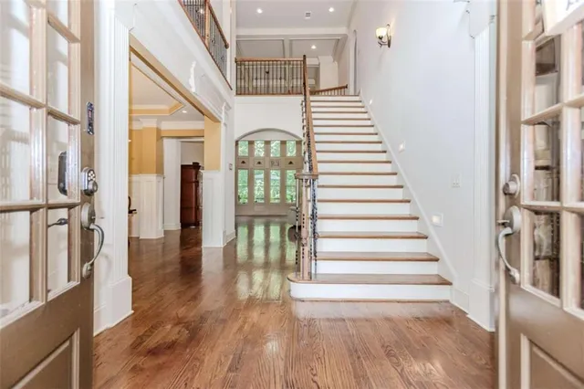 a view of entryway and hall with wooden floor