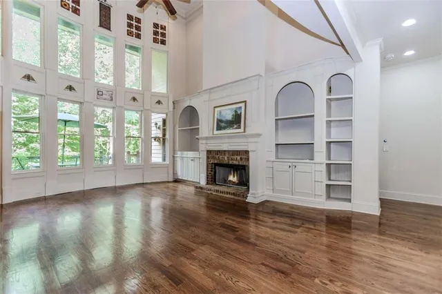 a view of an empty room with window and fire place