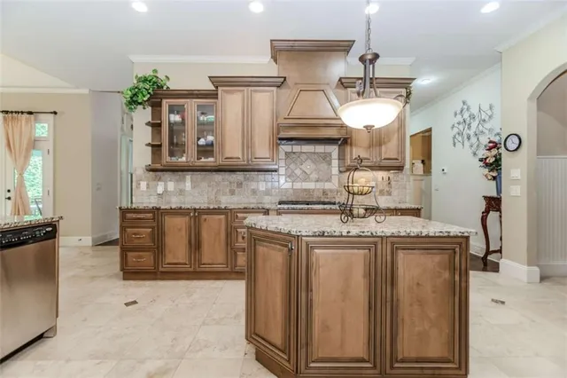 a kitchen with stainless steel appliances granite countertop a stove a sink and a refrigerator