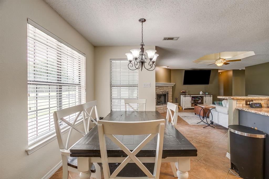 1050 Hampel Road Palmer, TX 75152 - Photo 14 of 35 a view of a dining room with furniture a chandelier and large windows