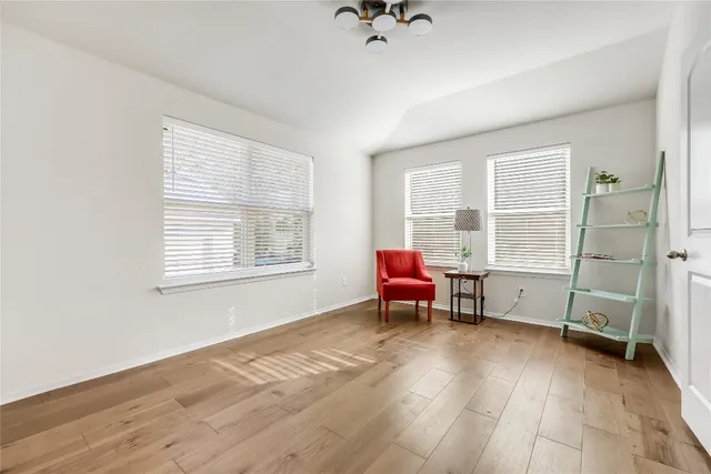 an empty room with chair and a window