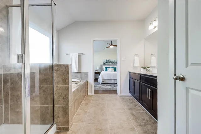 a large bedroom with a large bed and a chandelier