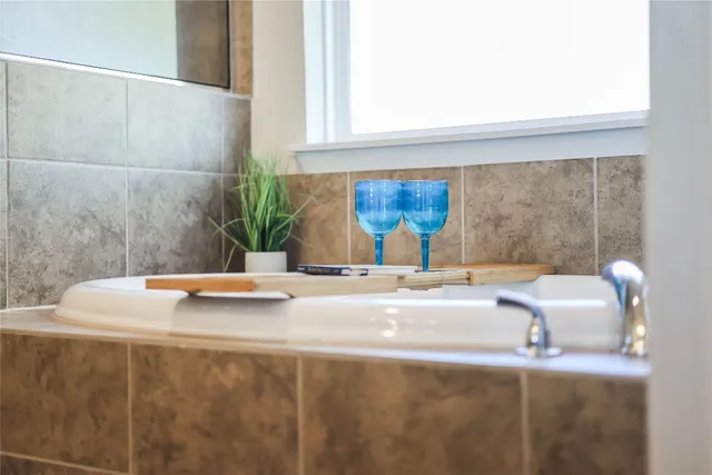 a view of a sink a counter top space and dining table with granite countertop