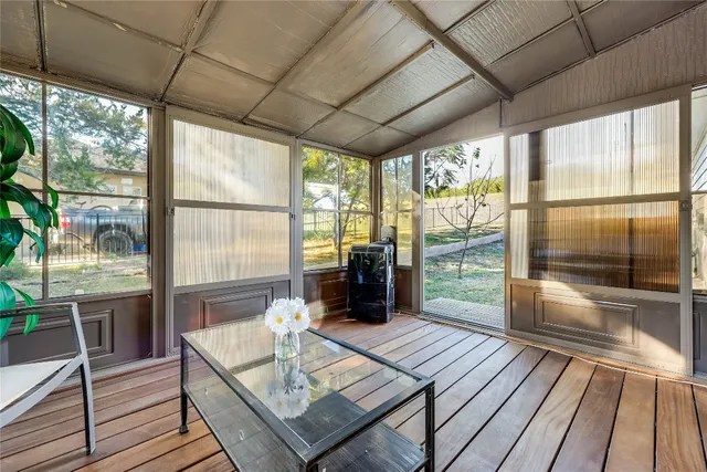a living room with a large window with kitchen view