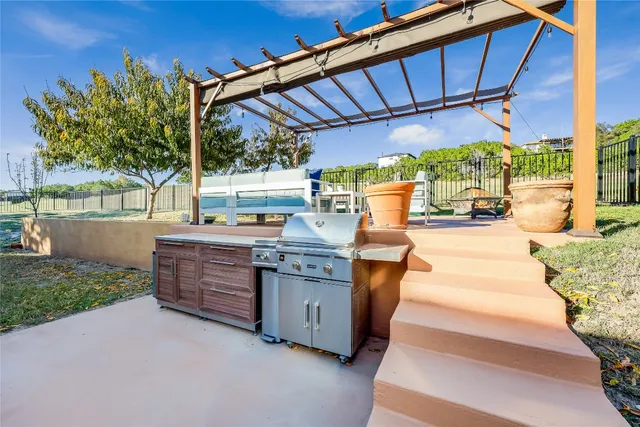 a view of patio with a table and chairs under an umbrella