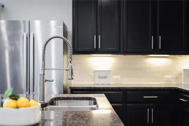 a kitchen with a sink and a refrigerator
