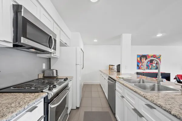 a kitchen with stainless steel appliances granite countertop a stove and a sink