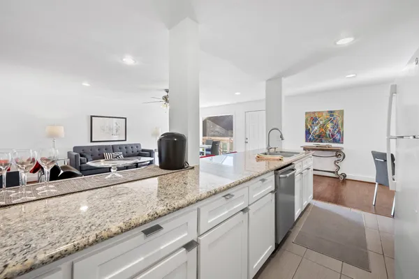 a large kitchen with a sink and large stainless steel appliances