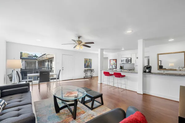 a living room with furniture and wooden floor