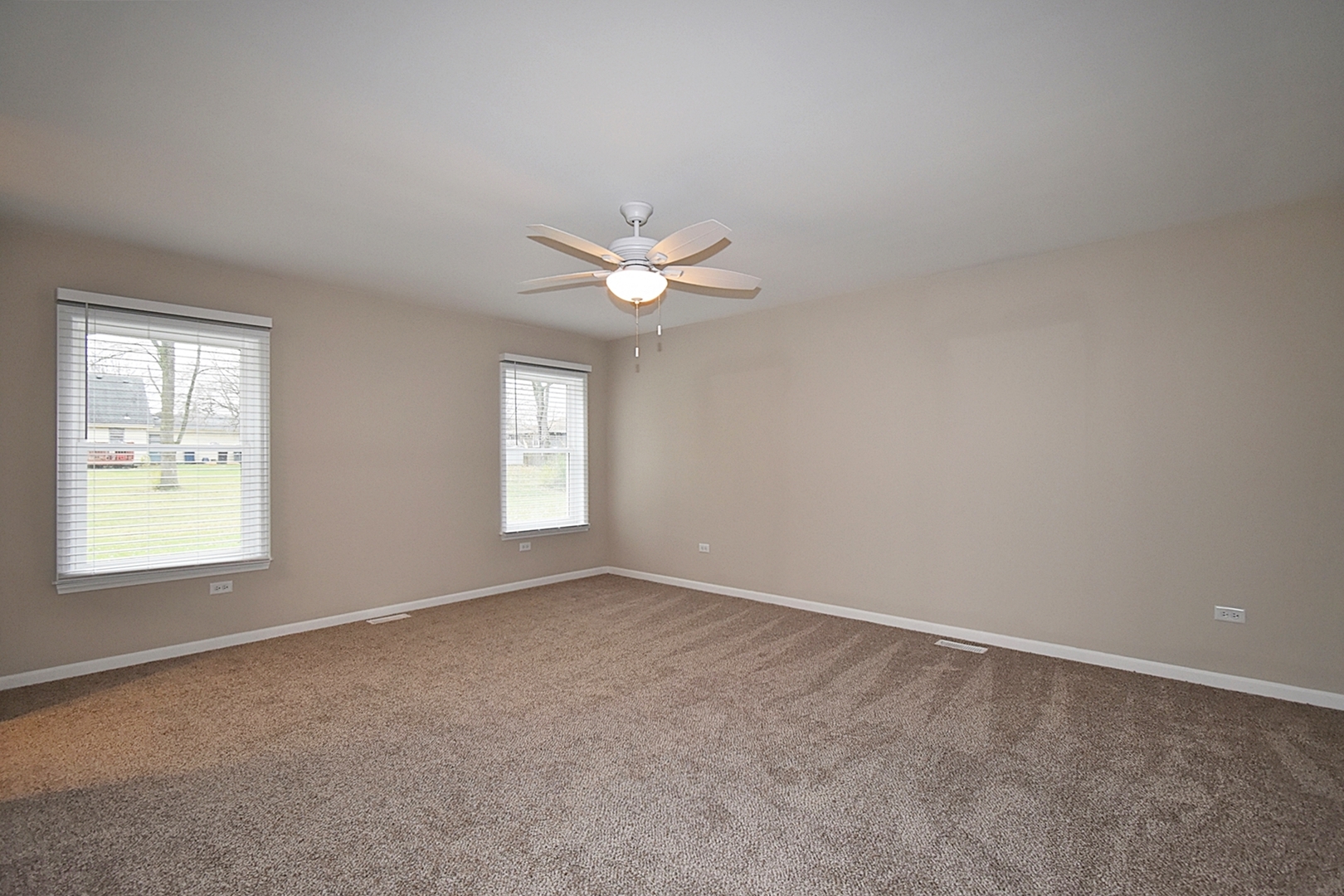 1191 Meadow Lane Elgin, IL 60123 - Photo 13 of 35 an empty room with windows and fan