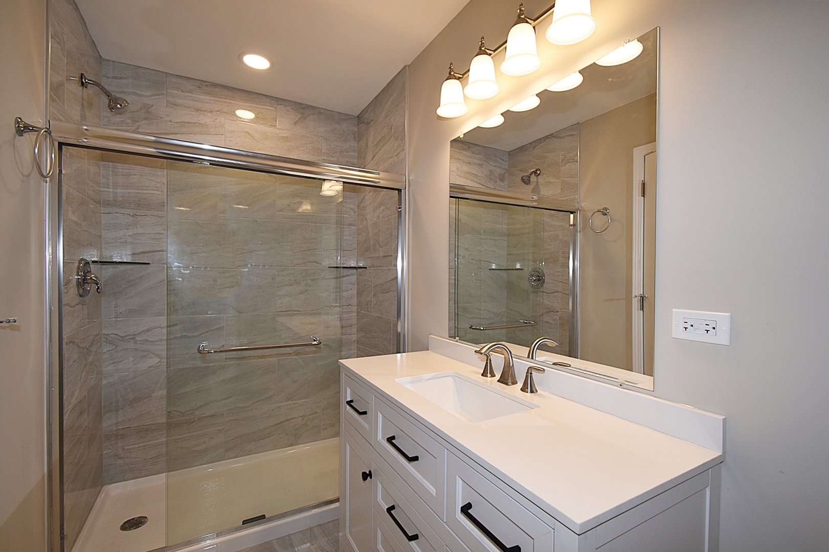 1191 Meadow Lane Elgin, IL 60123 - Photo 14 of 35 a bathroom with a shower sink vanity and mirror