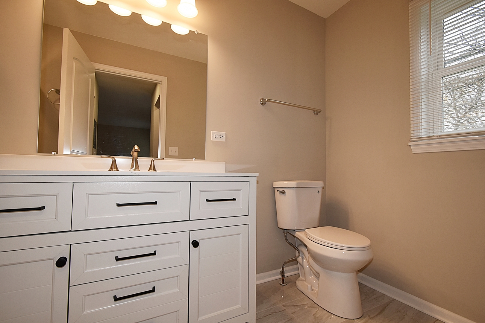 1191 Meadow Lane Elgin, IL 60123 - Photo 15 of 35 a bathroom with a toilet sink and mirror
