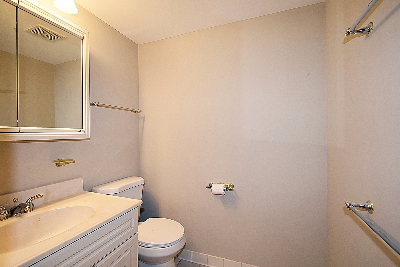 1191 Meadow Lane Elgin, IL 60123 - Photo 19 of 35 a white toilet sitting next to a bathroom sink