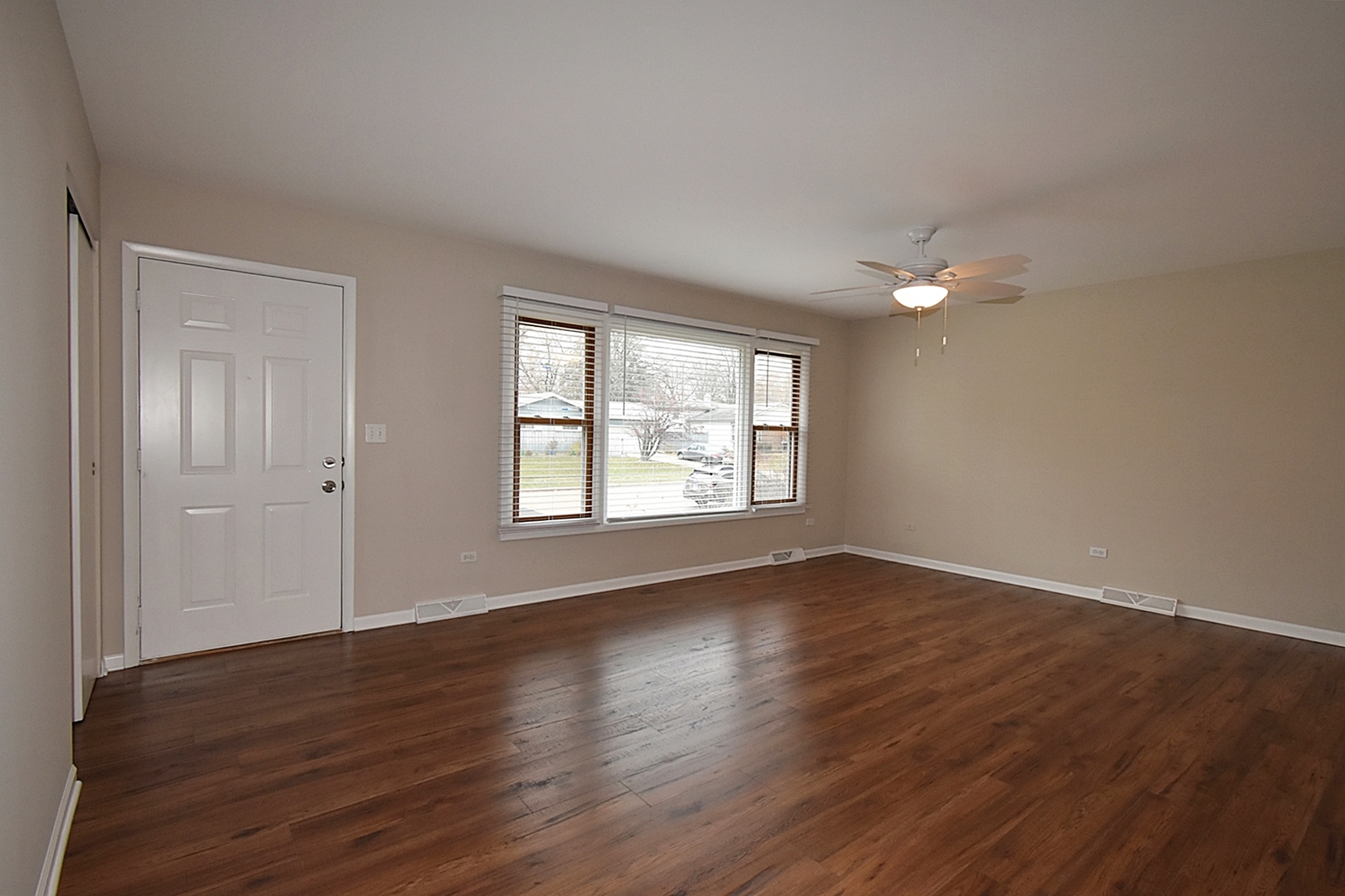 1191 Meadow Lane Elgin, IL 60123 - Photo 2 of 35 a view of an empty room with wooden floor and a window
