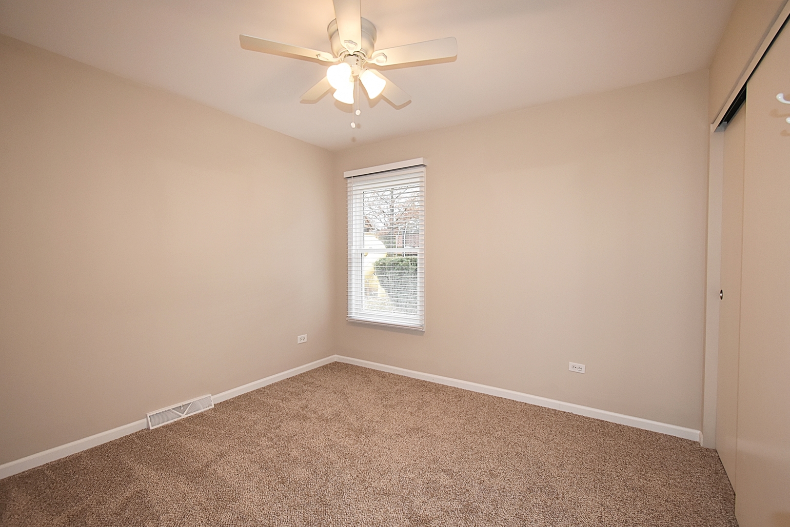 1191 Meadow Lane Elgin, IL 60123 - Photo 21 of 35 an empty room with a window and a fan