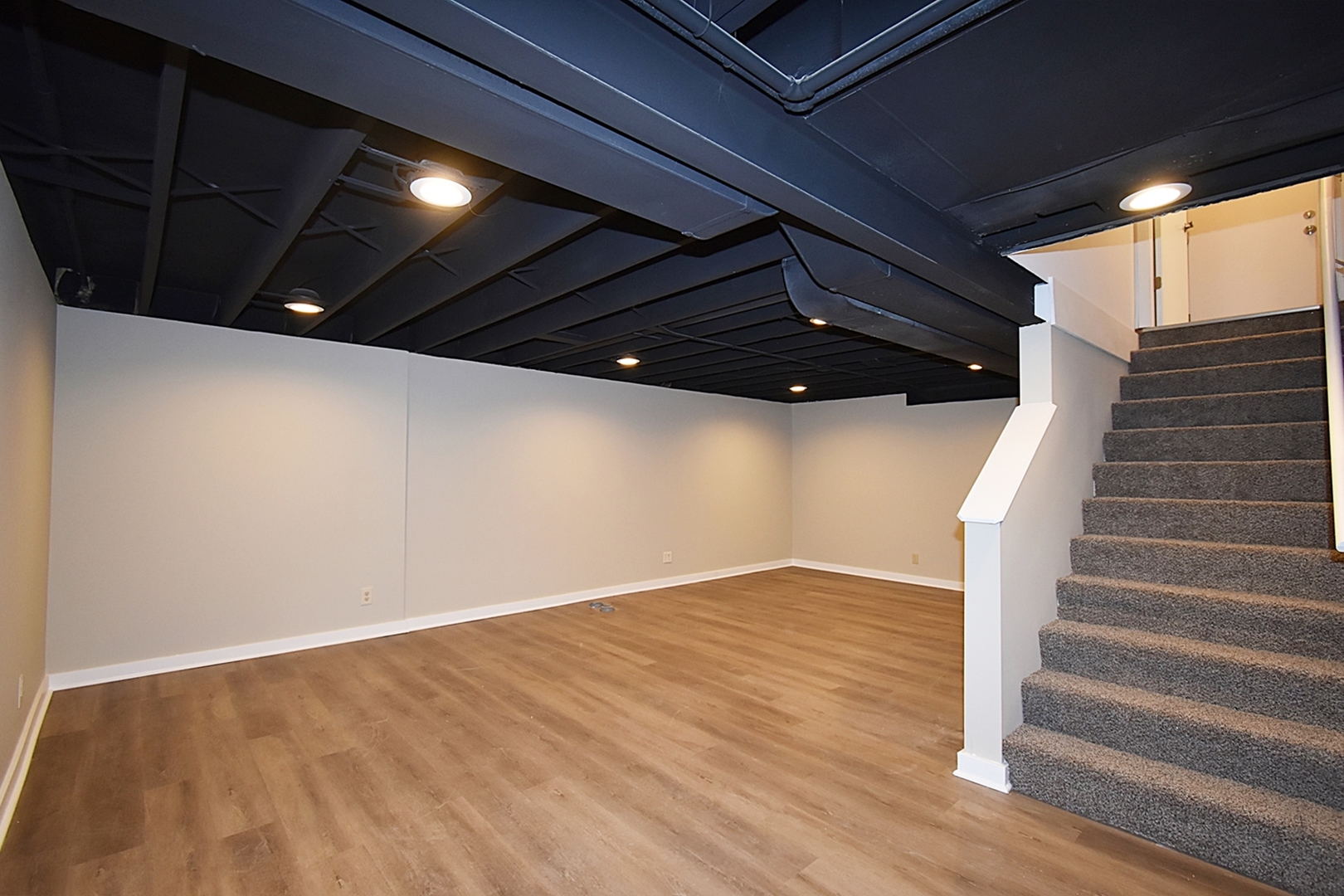 1191 Meadow Lane Elgin, IL 60123 - Photo 22 of 35 a view of an empty room with wooden floor and stairs