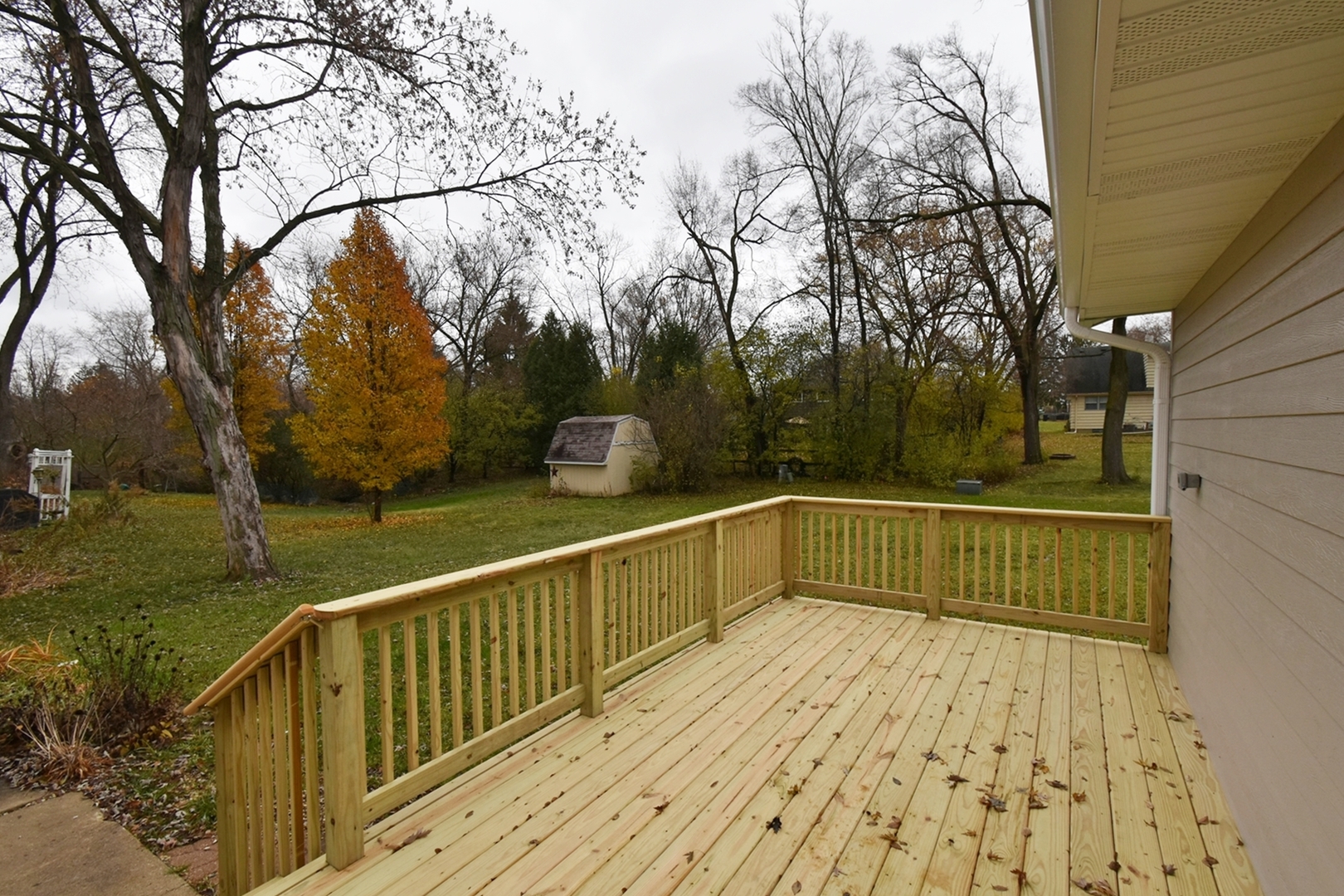 1191 Meadow Lane Elgin, IL 60123 - Photo 28 of 35 a view of balcony with wooden floor and trees