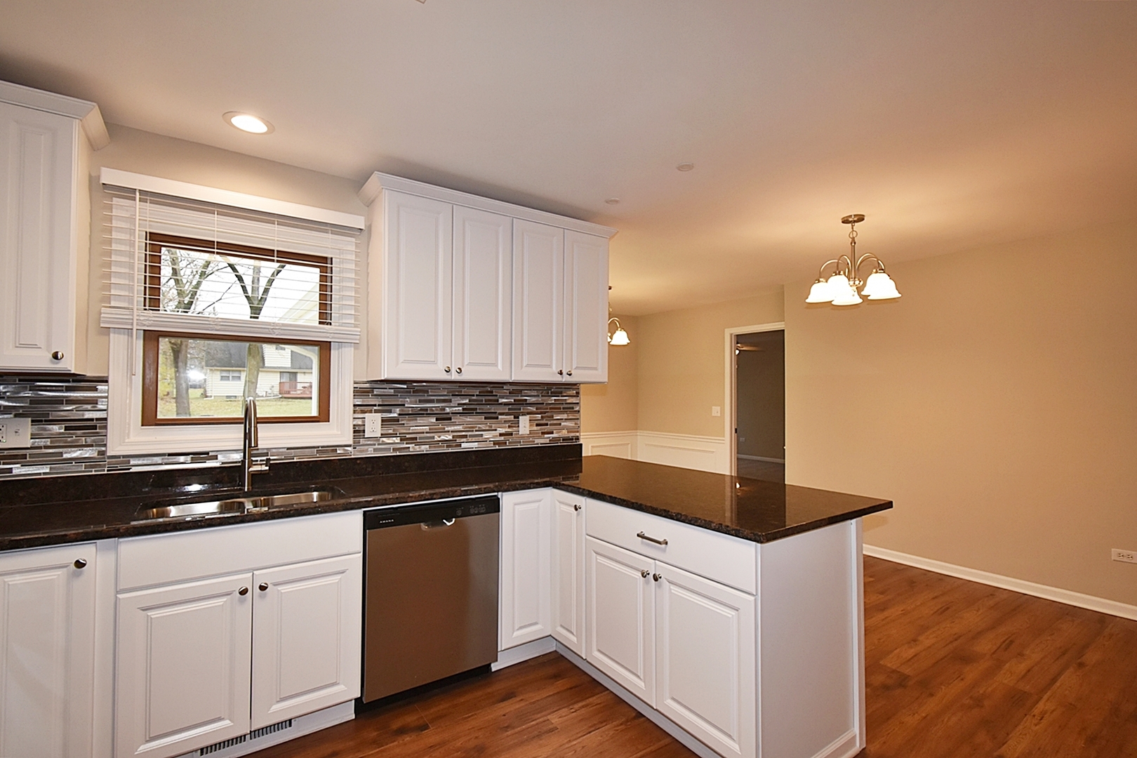 1191 Meadow Lane Elgin, IL 60123 - Photo 8 of 35 a kitchen with granite countertop white cabinets and white appliances