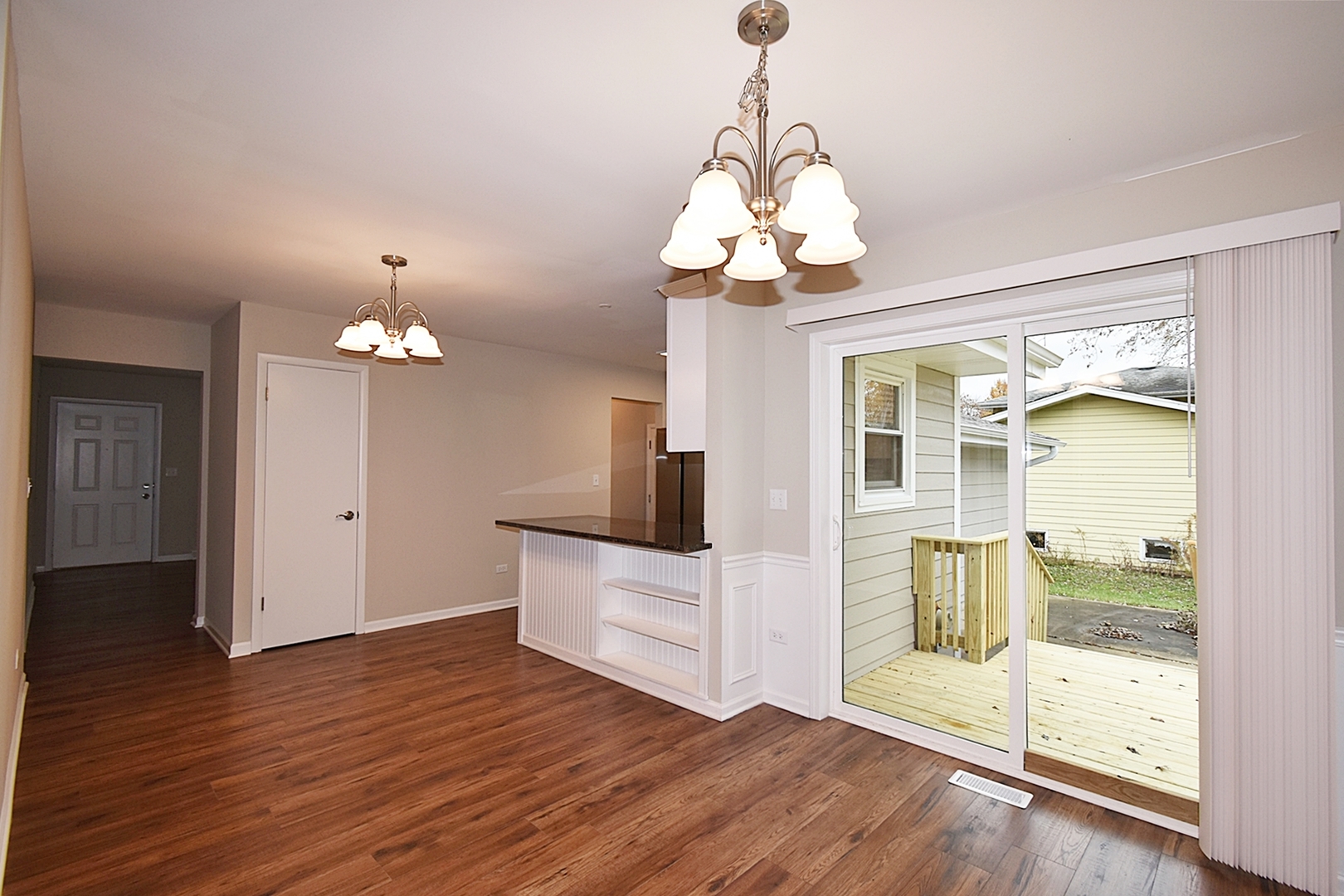 1191 Meadow Lane Elgin, IL 60123 - Photo 10 of 35 a view of a livingroom with wooden floor and a chandelier