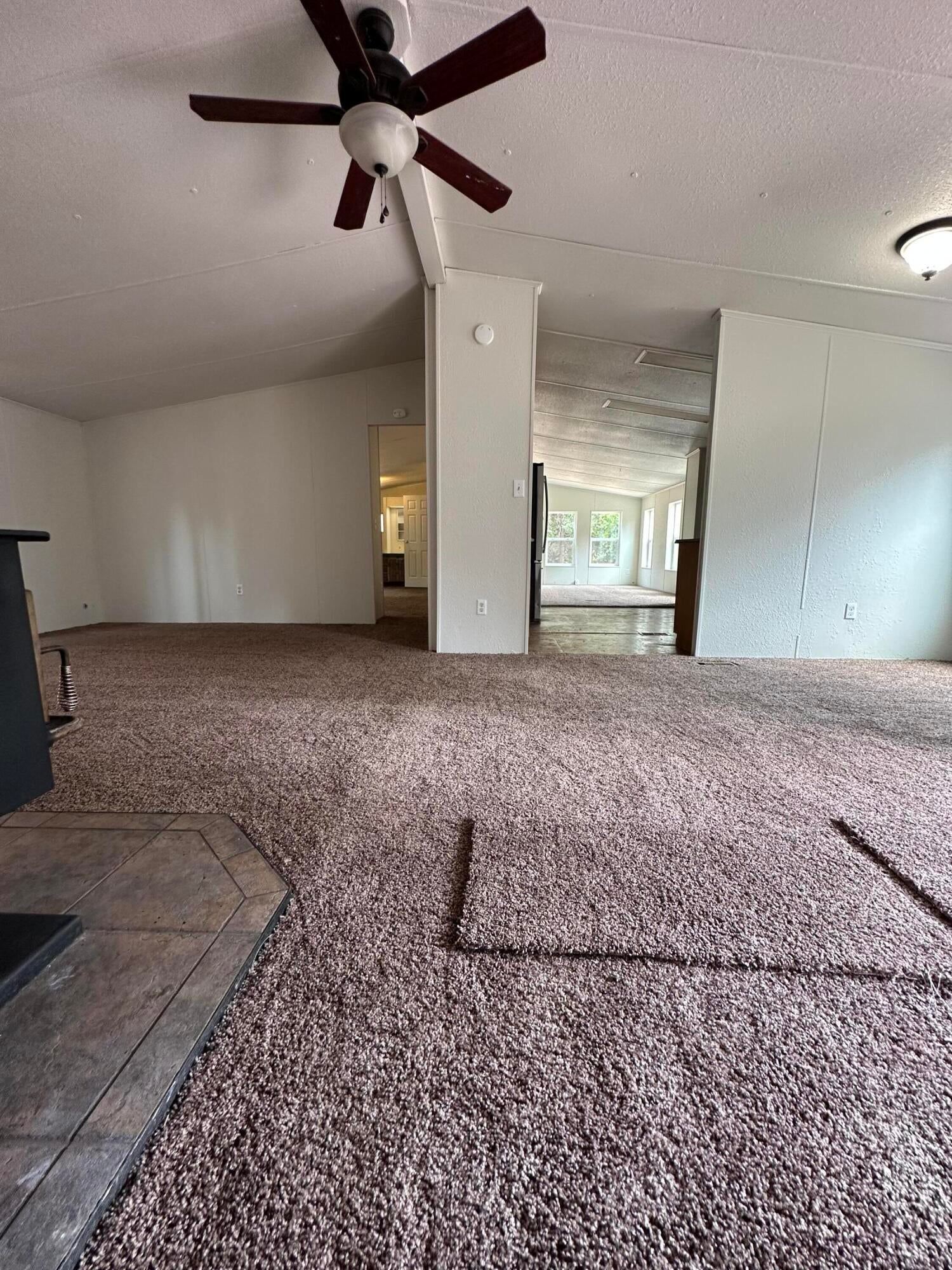 355 Crossway Drive Gold Hill, OR 97525 - Photo 14 of 23 Large open living room with dining area off to the side near the kitchen. Vaulted ceilings, new carpet, paint