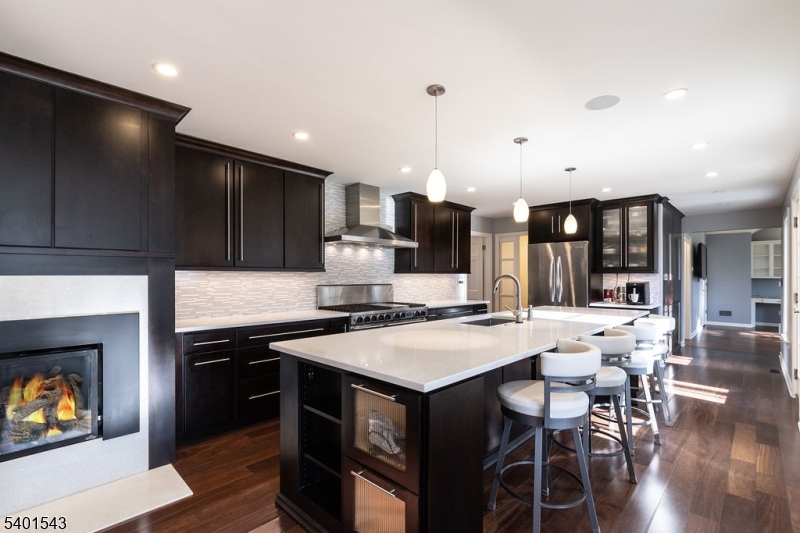 11 Wickham Way Chatham, NJ 07928 - Photo 13 of 47 a kitchen with stainless steel appliances a stove a sink a microwave a dining table and chairs