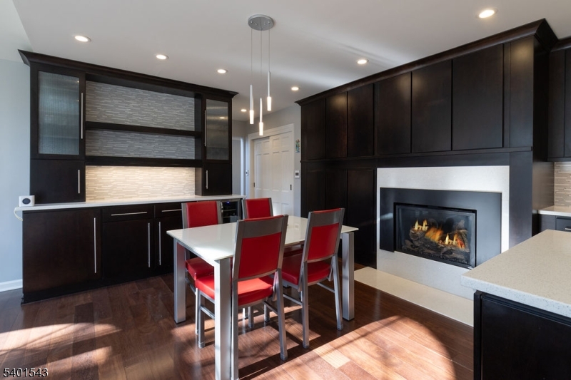 11 Wickham Way Chatham, NJ 07928 - Photo 16 of 47 a living room with stainless steel appliances furniture a fireplace and a projector