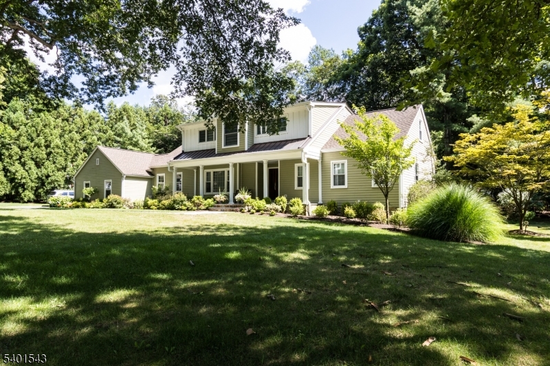 11 Wickham Way Chatham, NJ 07928 - Photo 2 of 47 a front view of a house with a yard table and chairs