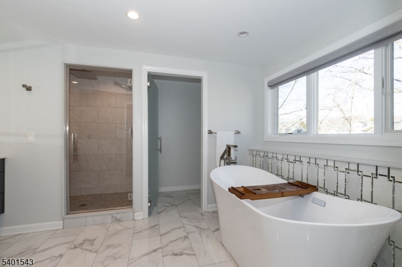 11 Wickham Way Chatham, NJ 07928 - Photo 30 of 47 a bathroom with a tub and shower
