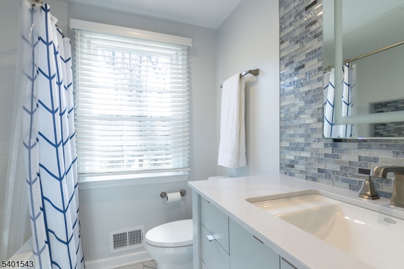11 Wickham Way Chatham, NJ 07928 - Photo 34 of 47 a bathroom with a sink a toilet and a window
