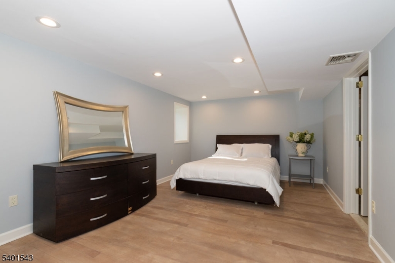 11 Wickham Way Chatham, NJ 07928 - Photo 38 of 47 a bedroom with a bed and a dresser