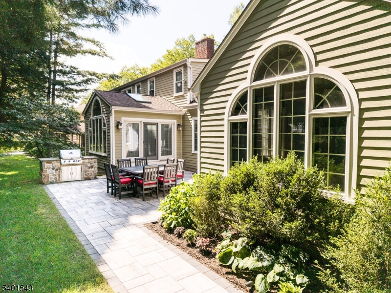 11 Wickham Way Chatham, NJ 07928 - Photo 6 of 47 a front view of a house with a garden and plants