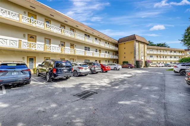 a view of a cars park in front of a building