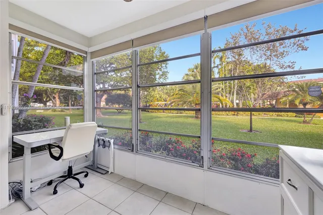 a view of a room that has a bed and a table