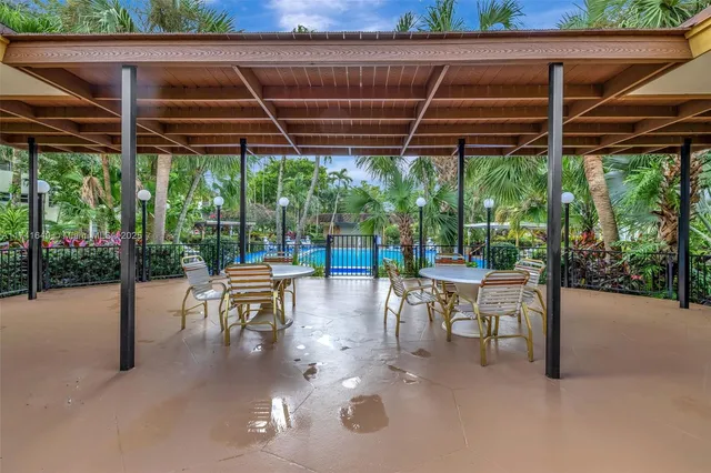 a view of a patio with a table and chairs