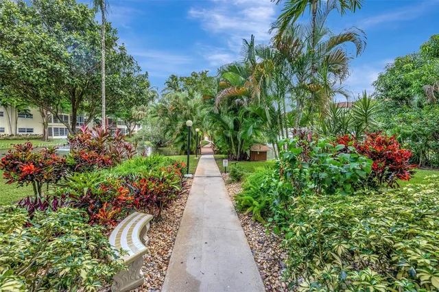a view of a garden with flowers and trees