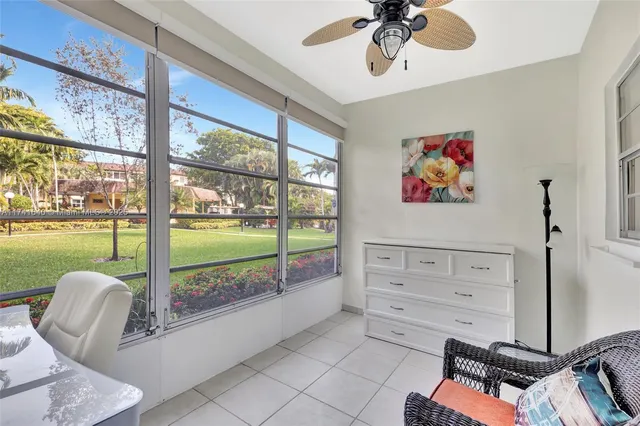 a view of a dining room with furniture water view and a floor to ceiling window