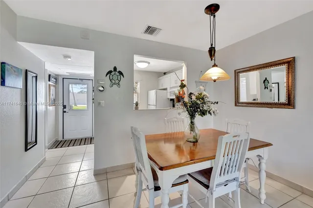 a dining room filled with furniture and chandelier
