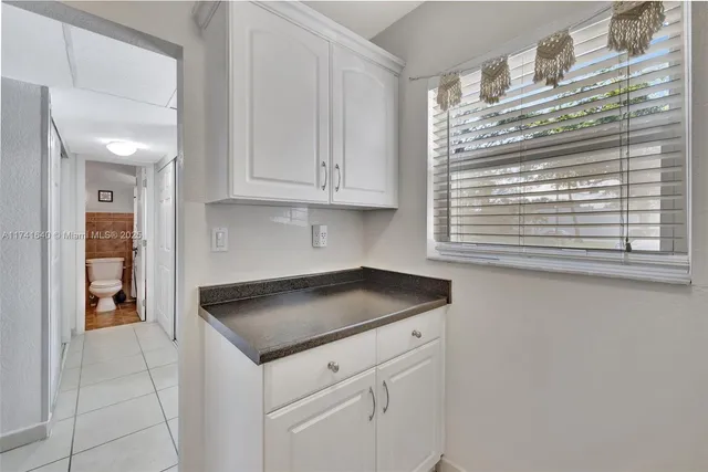 a kitchen with granite countertop a sink and a stove