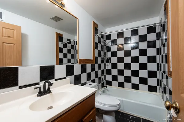 a bathroom with a sink a toilet a shower and a mirror