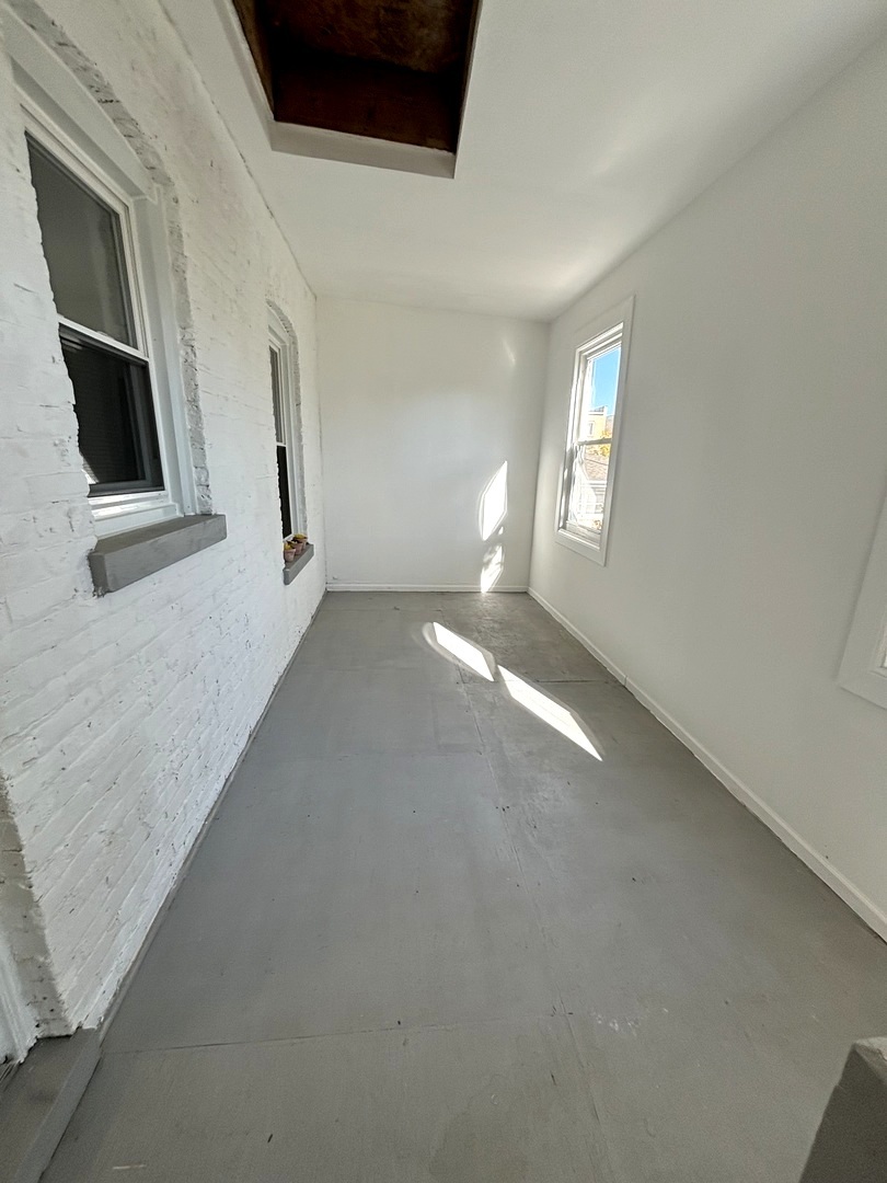 4741 North Keating Avenue Chicago, IL 60630 - Photo 18 of 25 a view of a livingroom with an empty space and a window