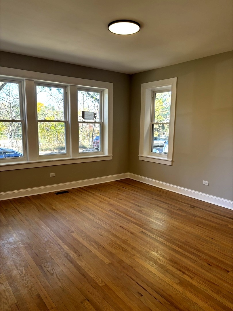 4741 North Keating Avenue Chicago, IL 60630 - Photo 5 of 25 a view of an empty room with wooden floor and a window