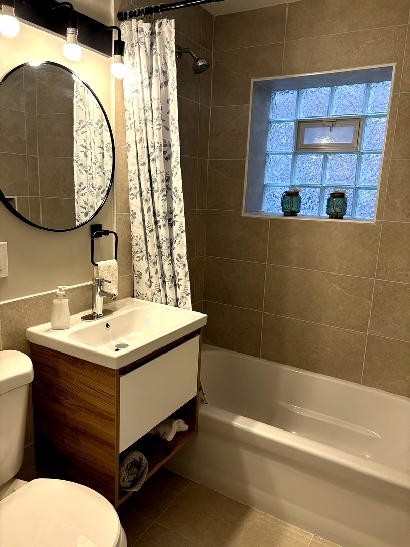 4741 North Keating Avenue Chicago, IL 60630 - Photo 8 of 25 a bathroom with a sink and a mirror