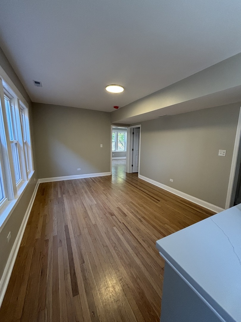 4741 North Keating Avenue Chicago, IL 60630 - Photo 10 of 25 a view of an empty room with wooden floor and a window