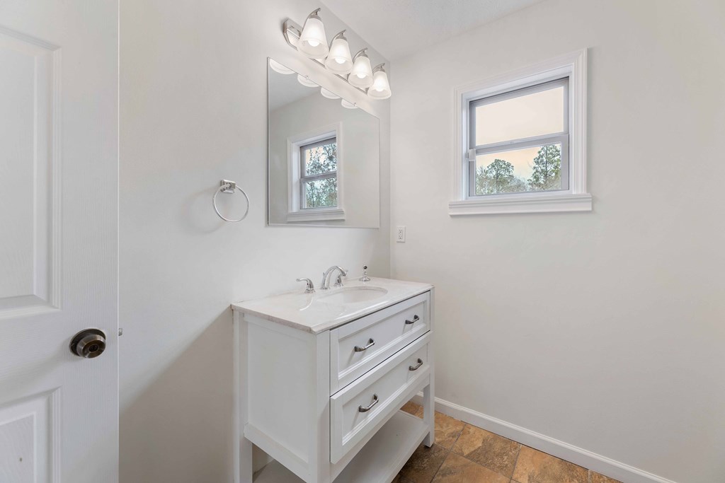 322 Moores Chapel Road Mauk, GA 31058 - Photo 15 of 34 a bathroom with a sink a mirror and a window
