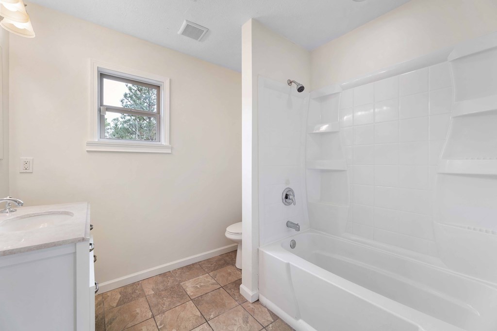 322 Moores Chapel Road Mauk, GA 31058 - Photo 16 of 34 a bathroom with a bathtub a toilet and a shower