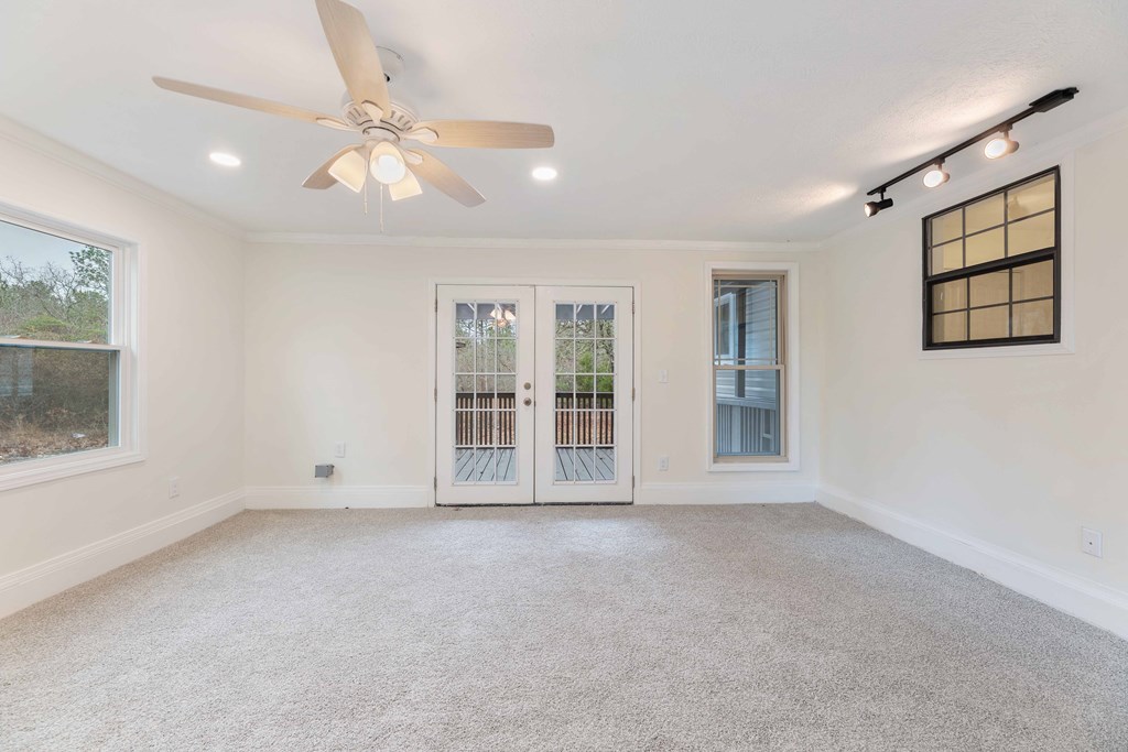 322 Moores Chapel Road Mauk, GA 31058 - Photo 26 of 34 an empty room with windows and chandelier fan