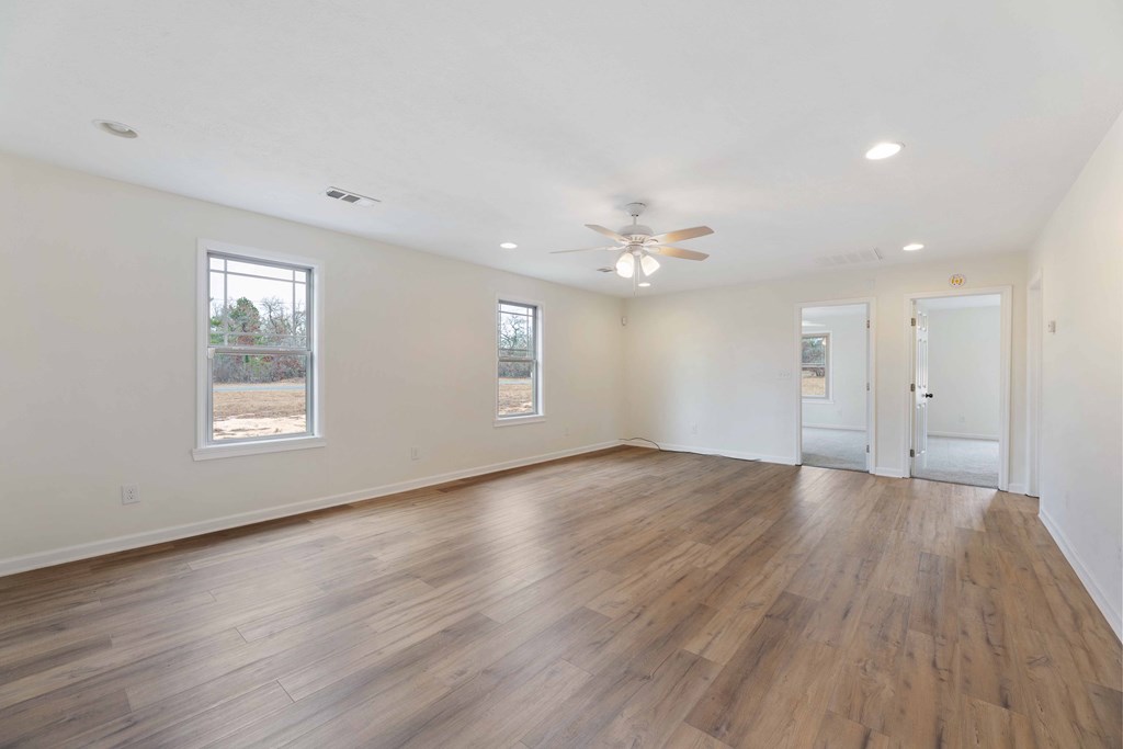 322 Moores Chapel Road Mauk, GA 31058 - Photo 4 of 34 a view of an empty room with wooden floor and window